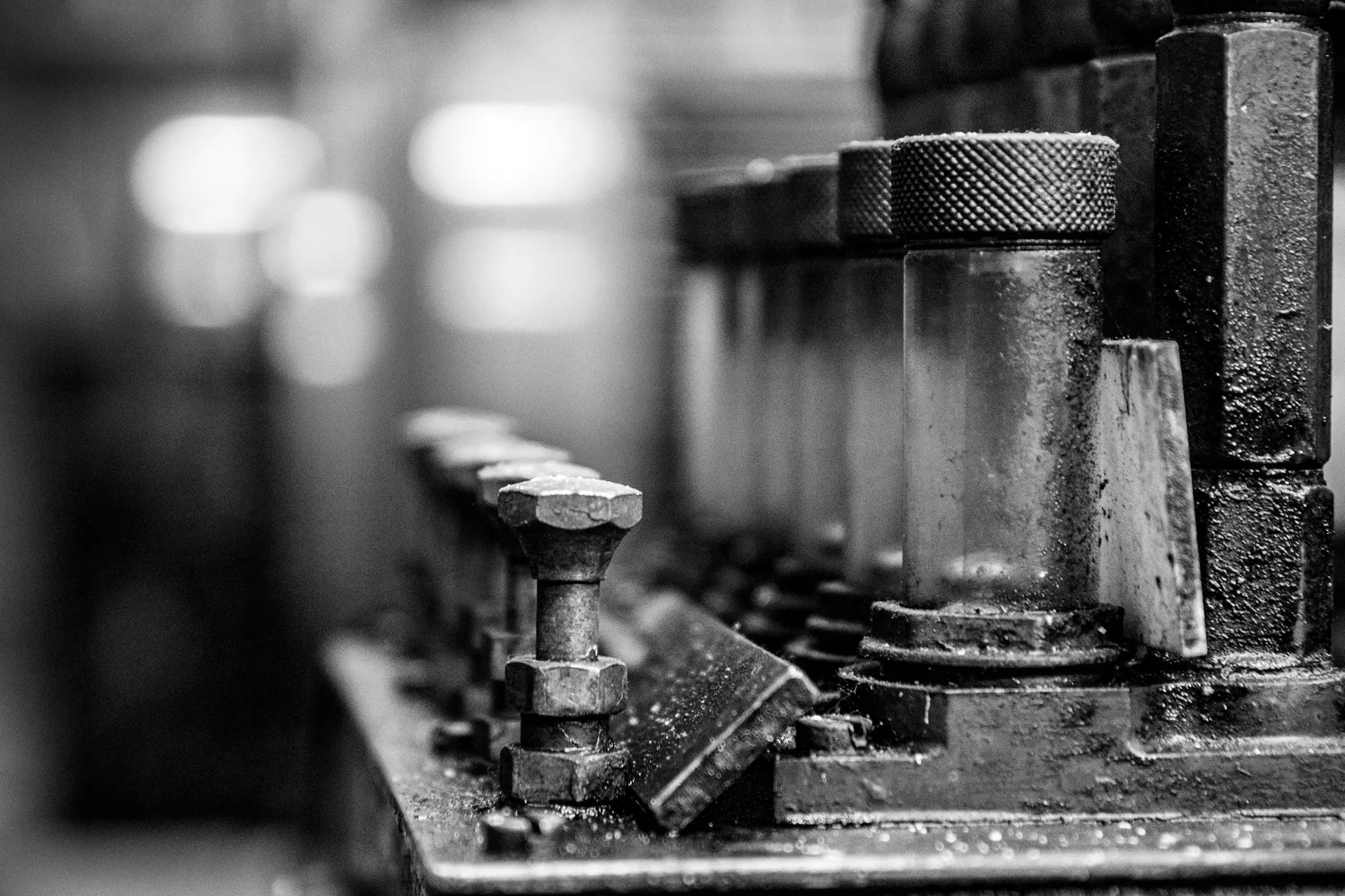 Industry context: Threaded bolts on an industrial metal assembly.