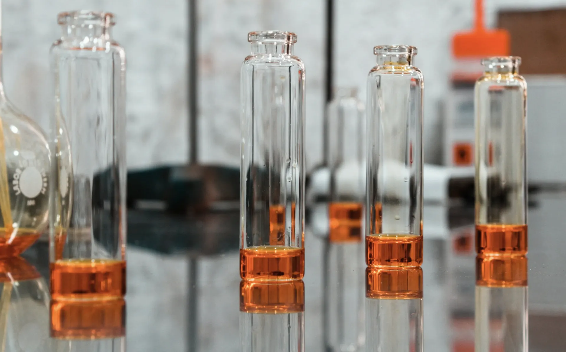 Industry context: Glass laboratory vessels with liquid samples.