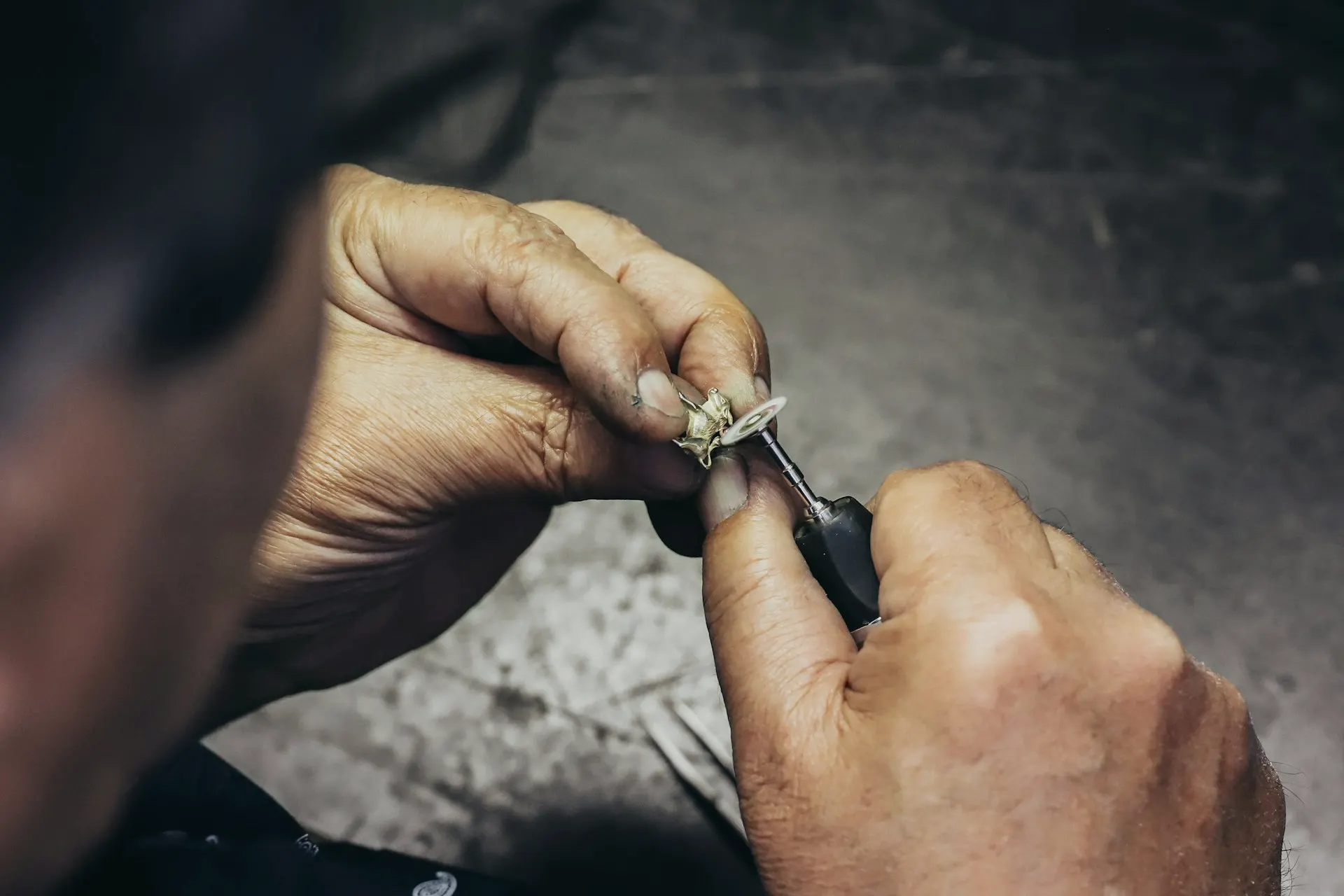 Industry context: Jeweller working on a small metal setting.