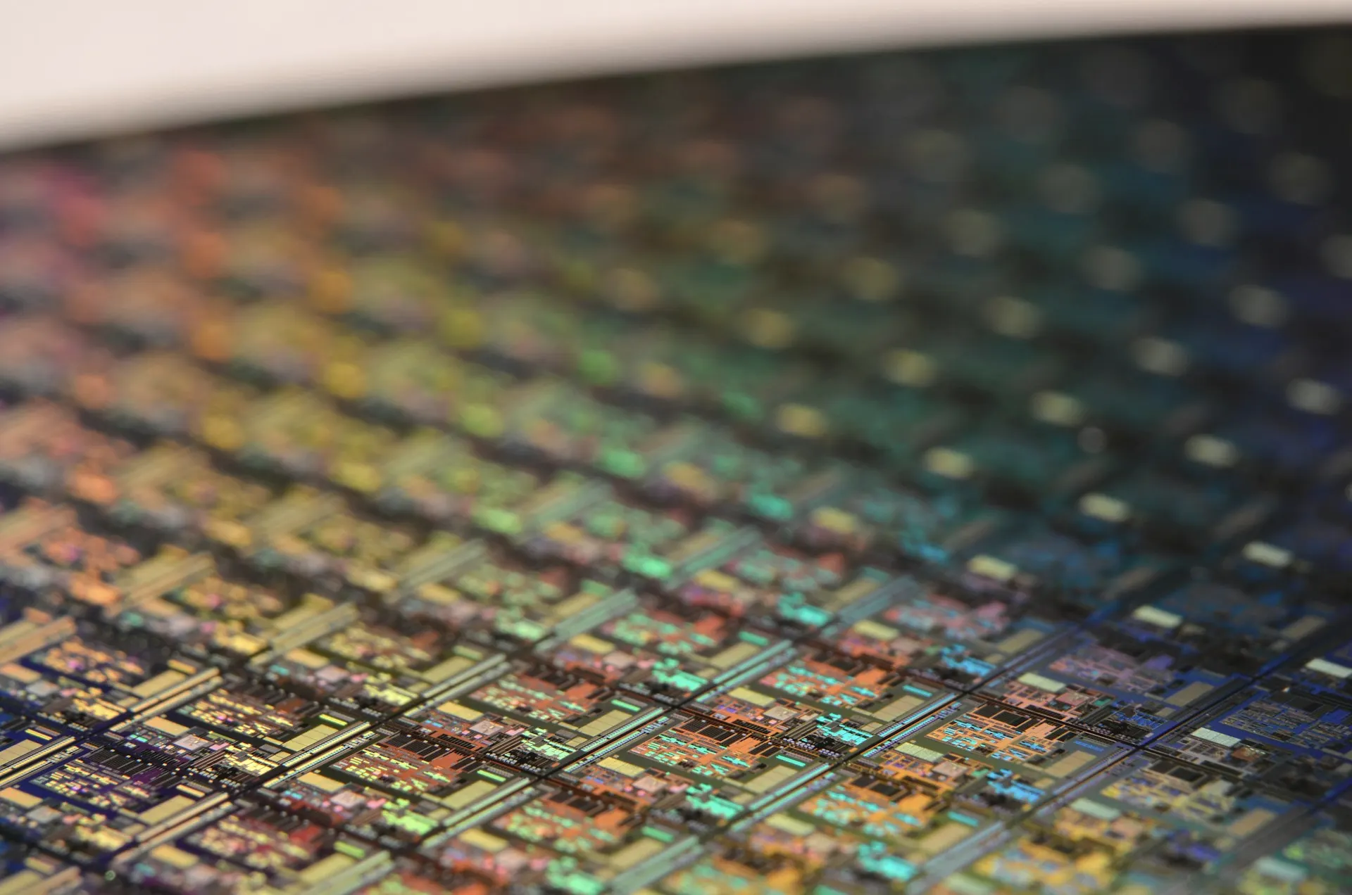Industry context: Macro photograph of silicon wafer circuits.