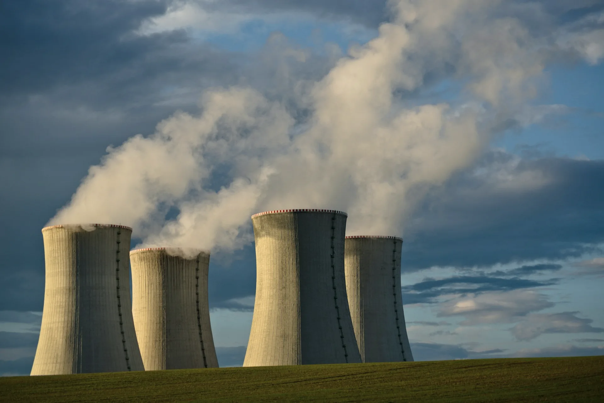 Industry context: Power station cooling towers releasing steam.