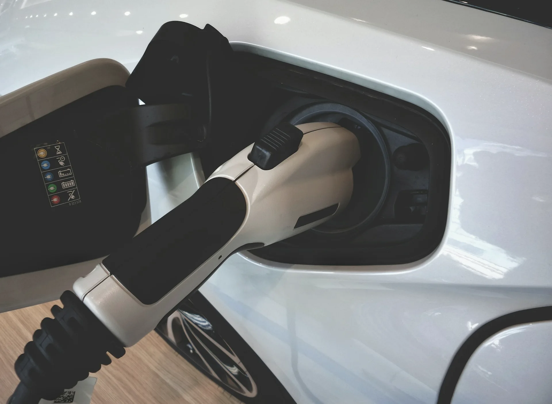 Industry context: Electric vehicle charging socket and cable.